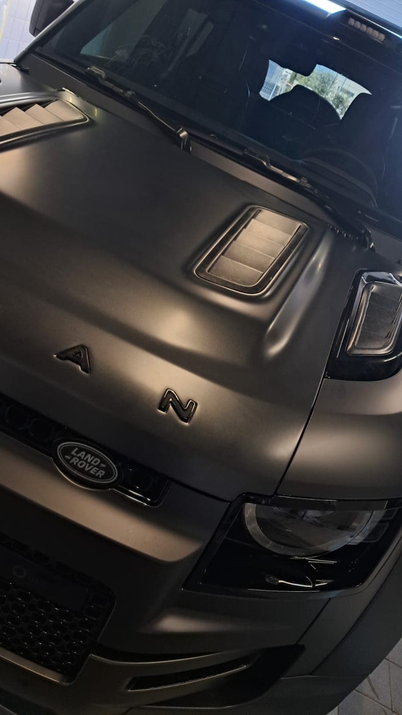 Range Rover in matte black, hood and grille detail
