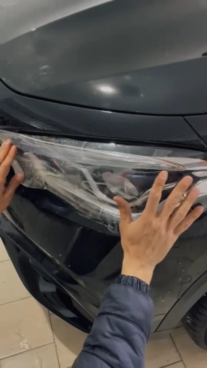 Protection film pressed over a black headlight unit