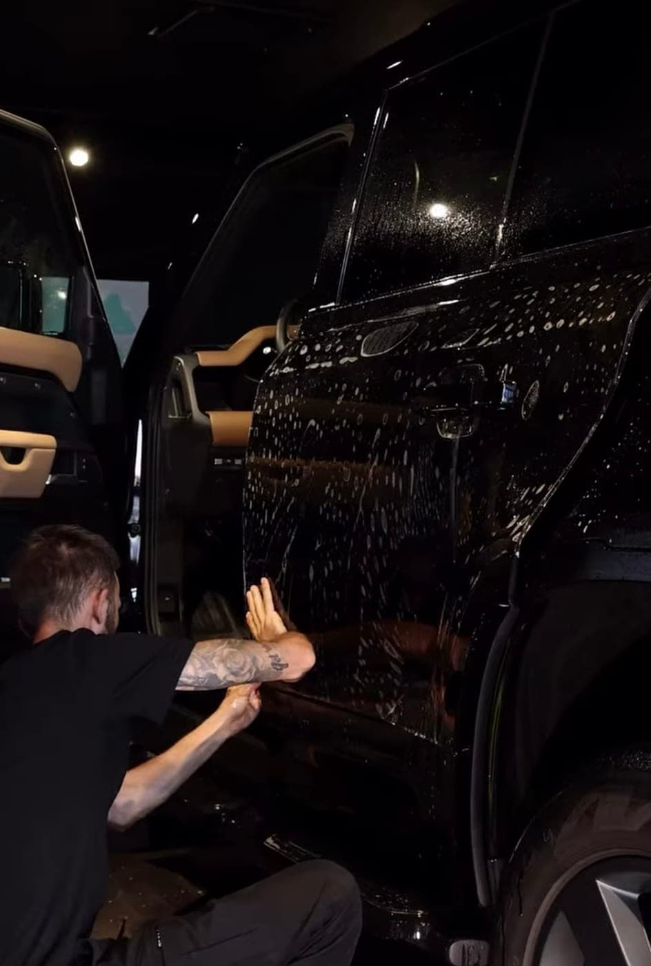 Protection film being laid onto a Land Rover Defender door
